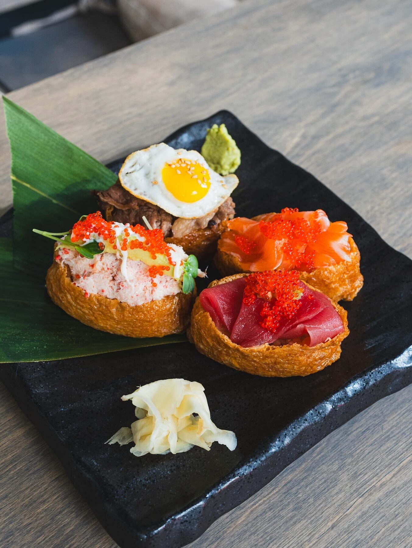 Inari on a stone plate with ginger and wasabi